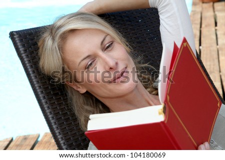 Portrait of woman reading book outside
