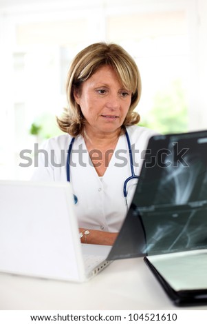 Woman doctor in office checking XRay