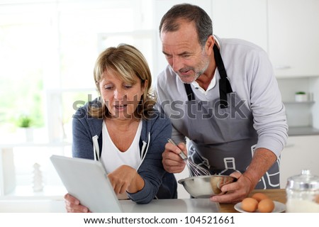 Senior couple having fun in home kitchen