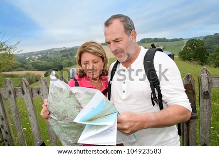Retired people reading map on trekking day