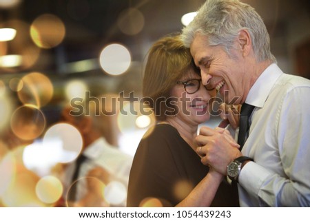 Romantic senior couple dancing together at dance hall