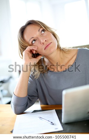 Woman at home having trouble to fill in tax form