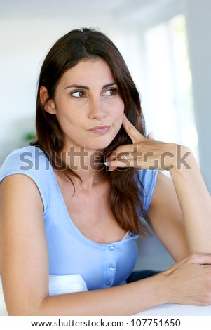 Brunette girl with questioning look on her face