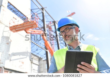 Construction supervisor inspecting building site
