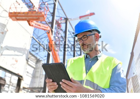 Construction supervisor inspecting building site