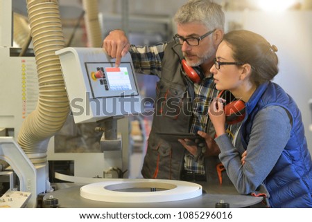Woman in professional training, wood industrial site