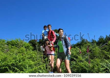 Family on a hiking day going down hill
