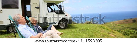 Senior couple relaxing in camping folding chairs, template