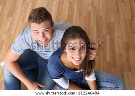 Upper view of young couple sitting on the floor