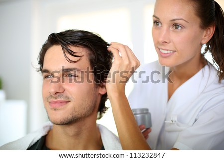 Hairdresser applying hair gel