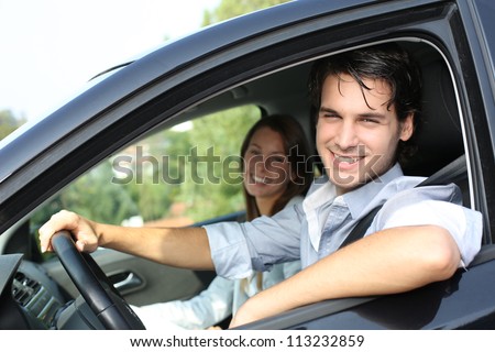 Cheerful couple driving car