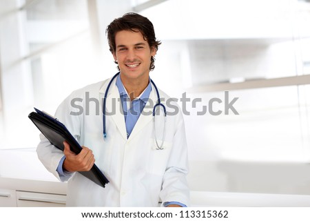 Cheerful student in medicine standing in hospital hallway