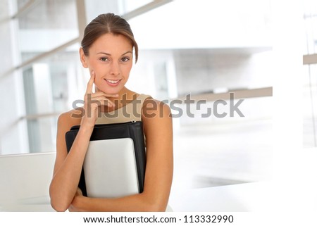 Smiling businesswoman in building hall