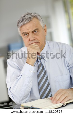 Senior businessman being serious in front of client