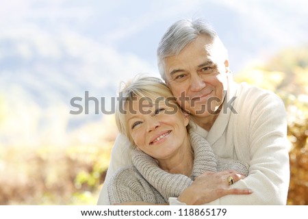 Senior Couple Embracing Each Other In Countryside