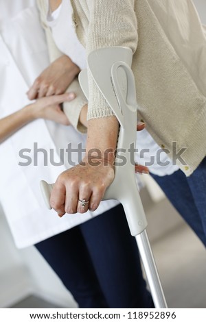 Closeup of old woman\'s hands leaning on crutches