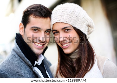 Portrait of trendy couple in town