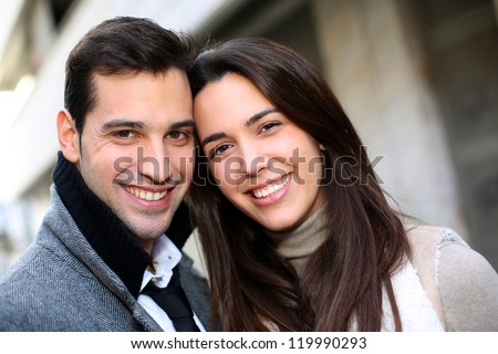 Portrait of trendy couple in town