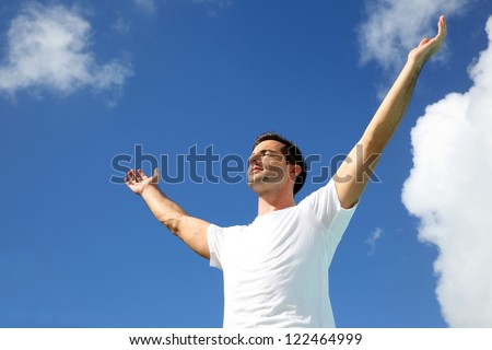 Man stretching arms up towards the sky