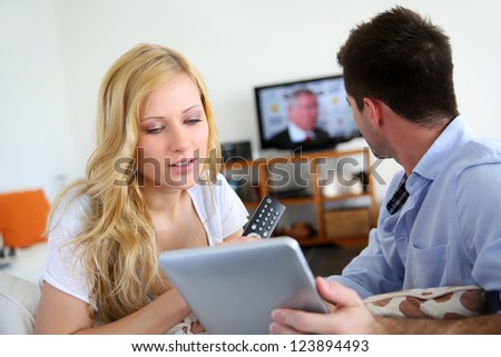 Young couple choosing tv program on internet
