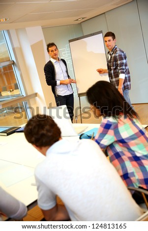 College teacher in class with group of students