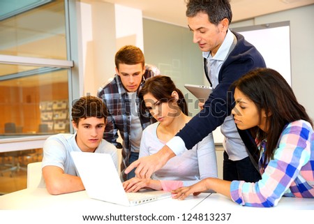 Group of students in computer training with teacher