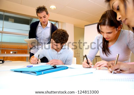 Teacher watching students writing exam