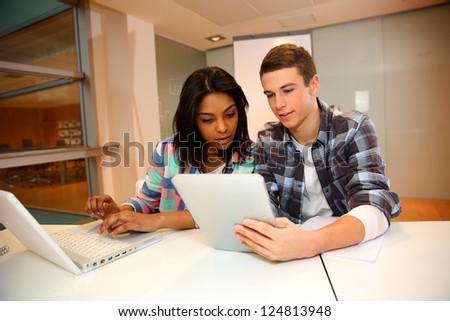 Teenagers in class using electronic tablet