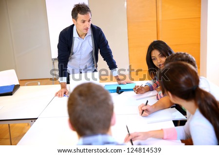 College teacher in class with group of students