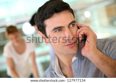 Businessman on the phone during work meeting