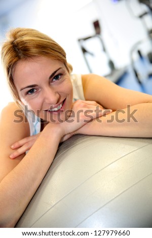 Portrait of fitness girl leaning on balance ball