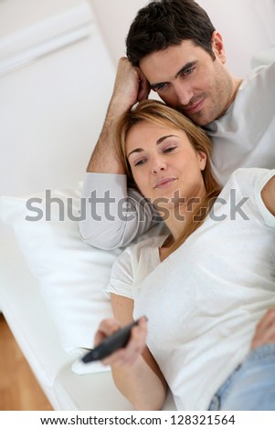 Sweet couple in sofa watching tv