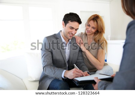 Couple Signing Terms Of Real-Estate Contract