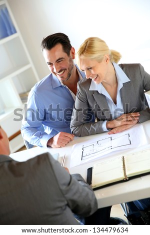 Couple meeting real-estate agent to buy property