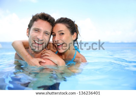 Couple having fun in swimming-pool