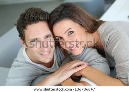 Upper view of sweet couple sitting in sofa
