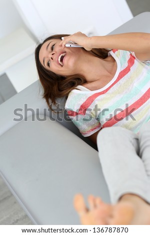 Young woman laughing out loud on the phone