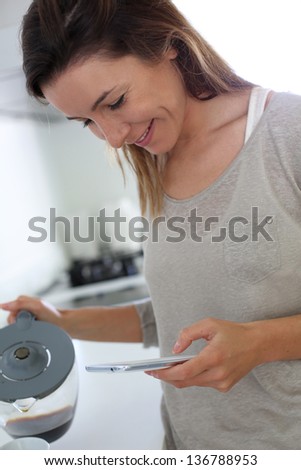 Young woman at home connected on smartphone