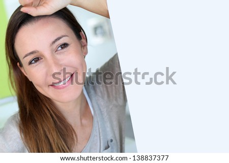 Beautiful brunette girl with hand on forehead
