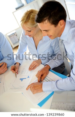 Upper view of business people meeting around table