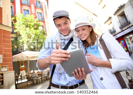Couple visiting Madrid with help of digital tablet