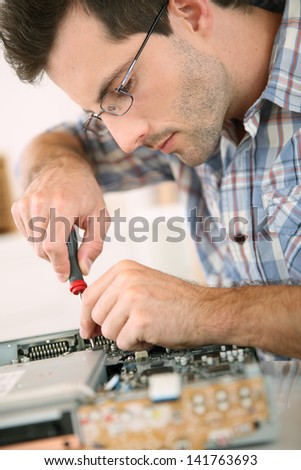 Man fixing electronic appliance