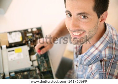 Man fixing electronic appliance