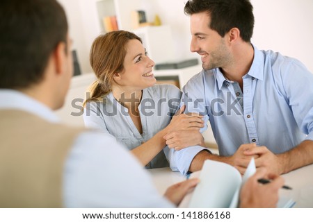 Young Couple Meeting Construction Planner