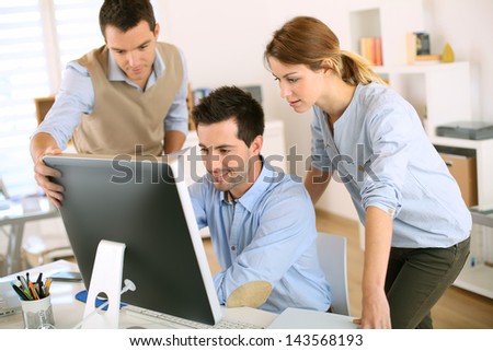 Workteam In Office Working On Desktop Computer