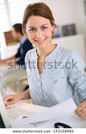 Young woman working on desktop colputer