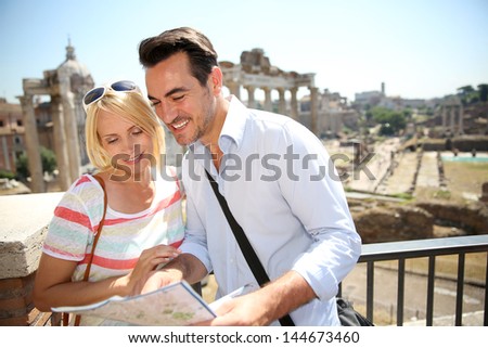 Couple of tourists reading city map by the Roman Forum