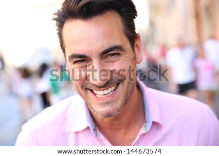 Closeup of handsome guy wearing pink shirt