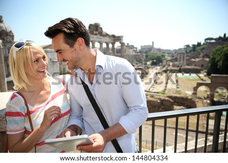 Couple of tourists using tablet by the Roman Forum
