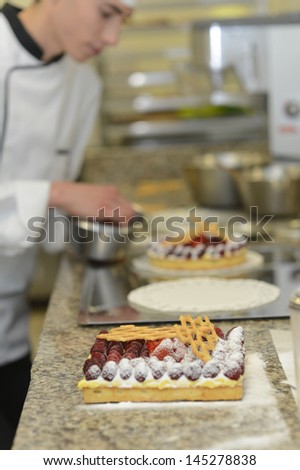 Pastry cook student making cake